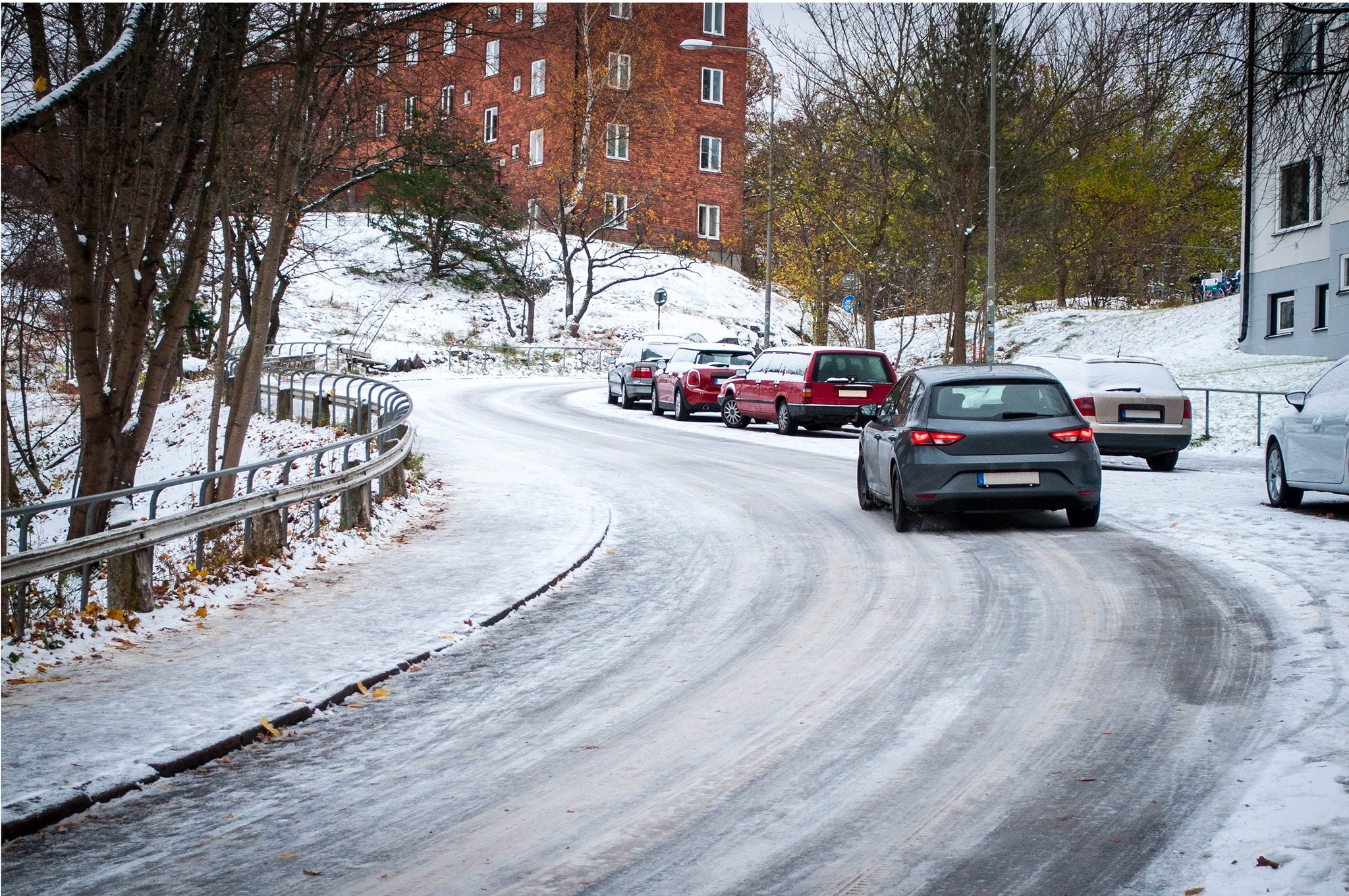 A car on a winter road in the city.