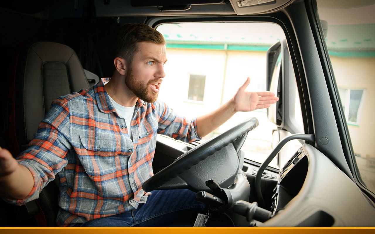 angry trucker shouting while sitting in a truck