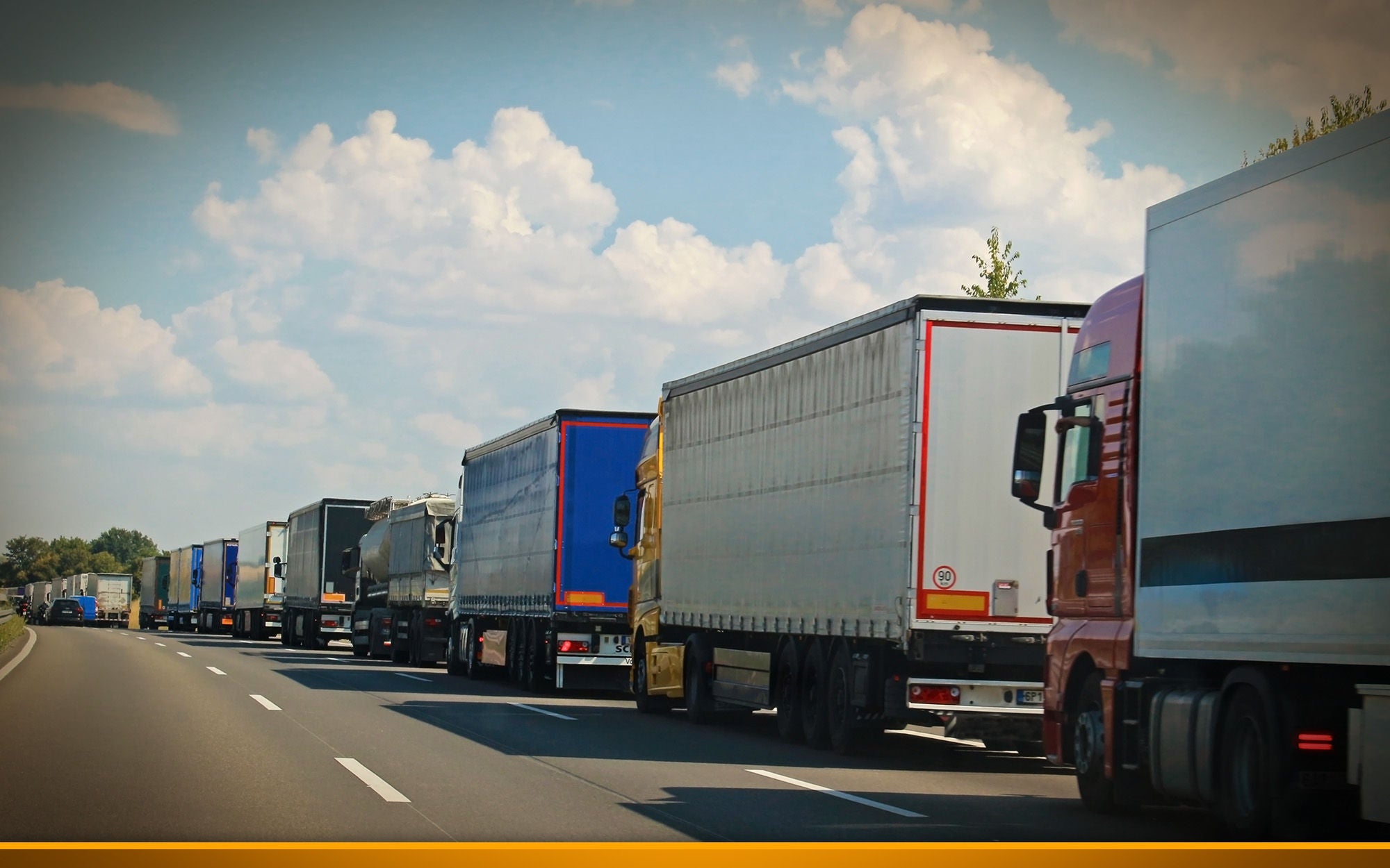 trucks stuck in traffic on a sunny day