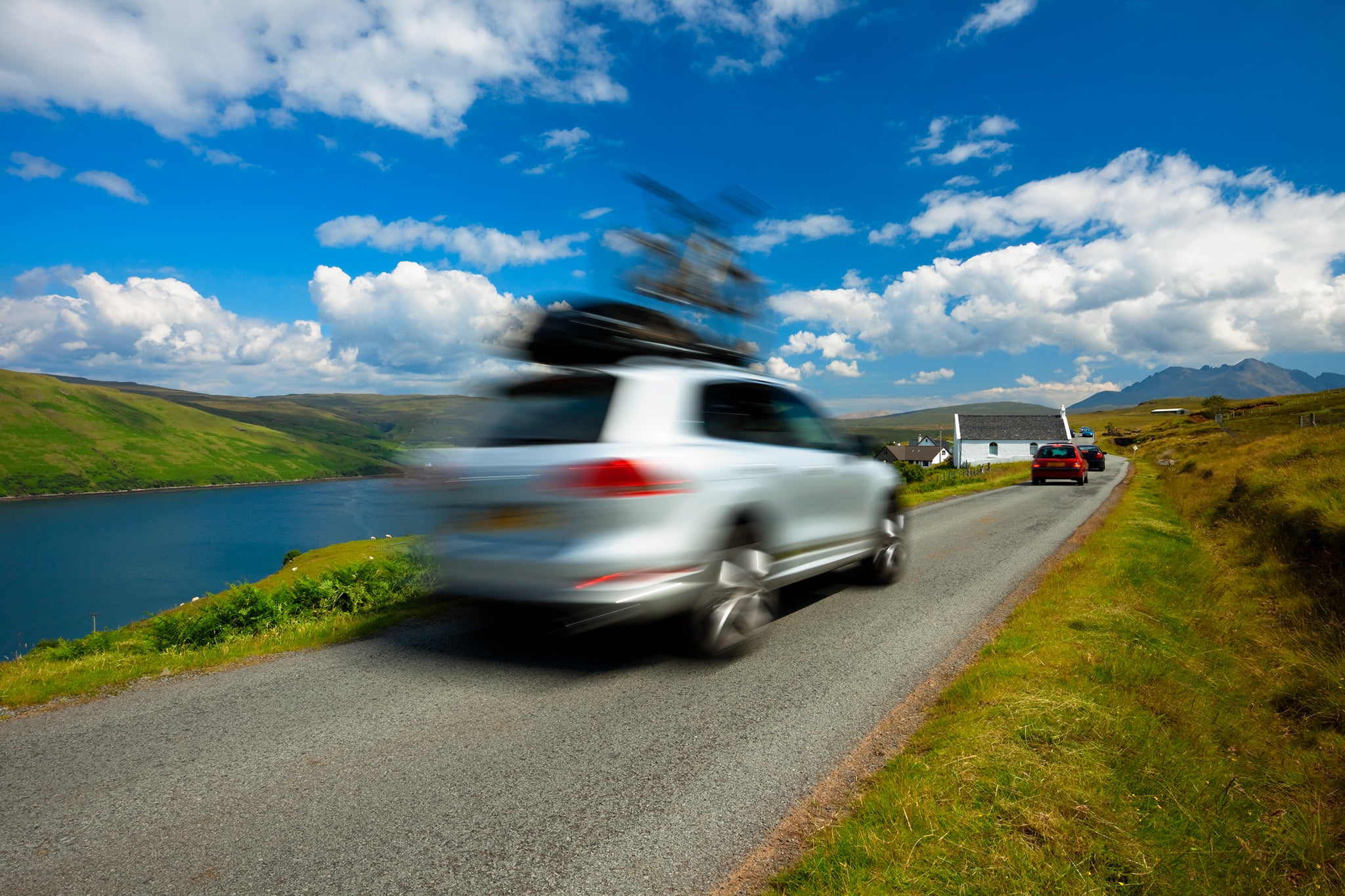 car driving with bike on roof on Isle of Skye; Blurred Motion, Scotland, UK,click below to view more related images: