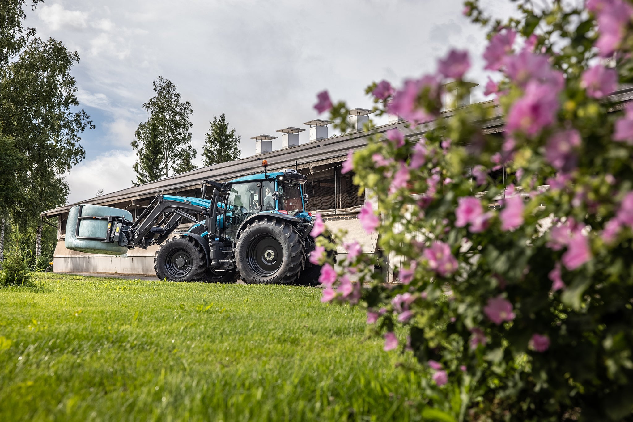 Valtra g 135 unlimited tervala moving hay bales on a farm.