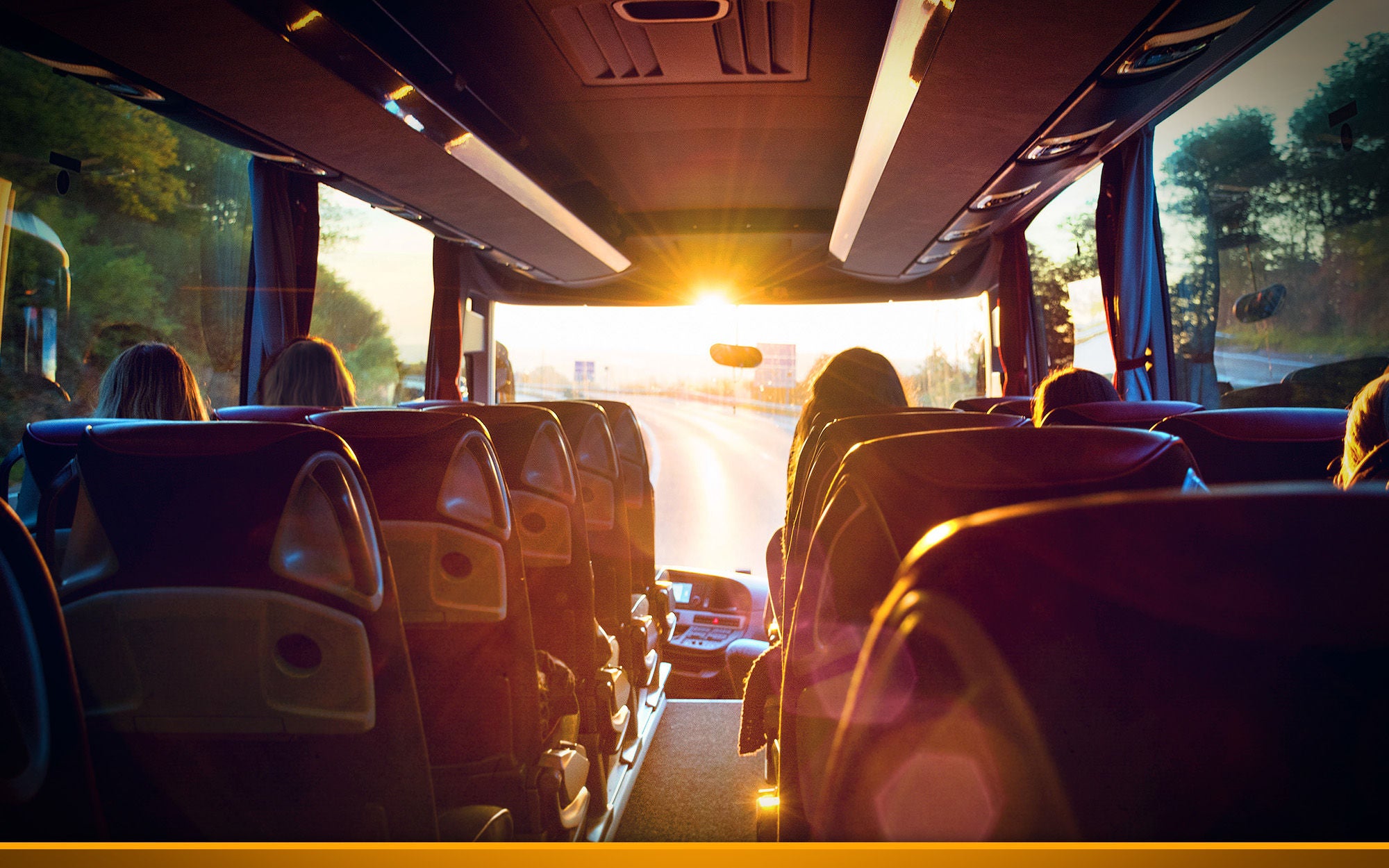 inside of a coach, sitting passengers in sunlight