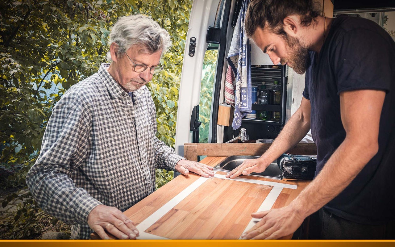 Two men with a wooden plank