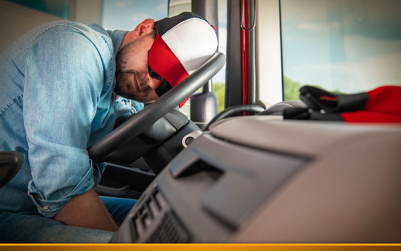 Trucker sleeping on wheel