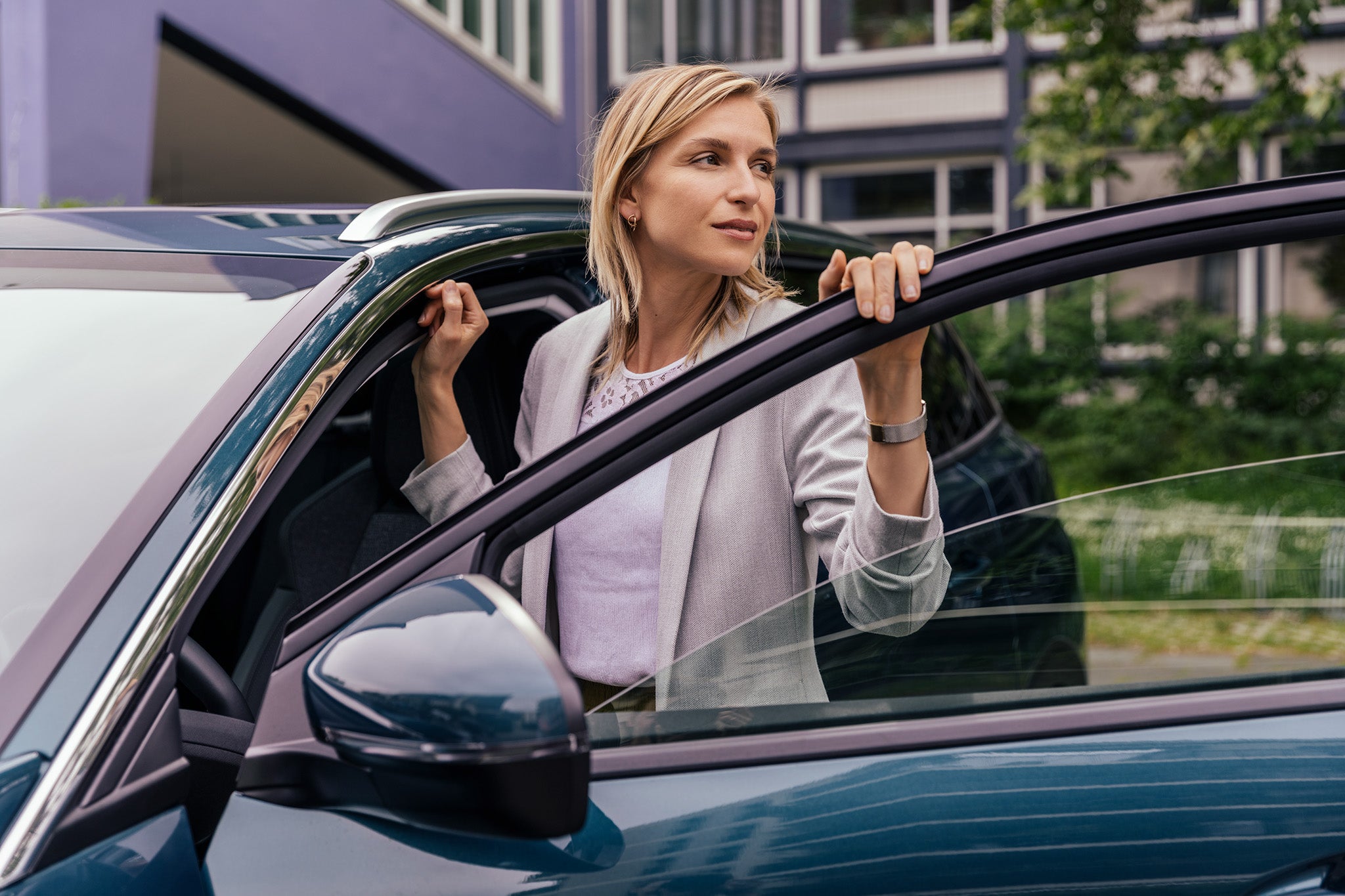 How AS tires work Woman leaning at open car door, Cologne, NRW, Germany