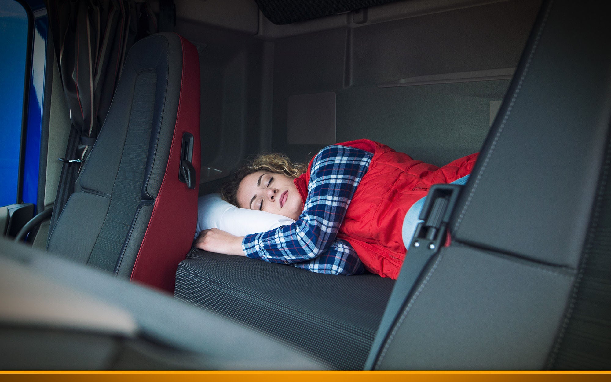 Person sleeping inside a cabin of a truck