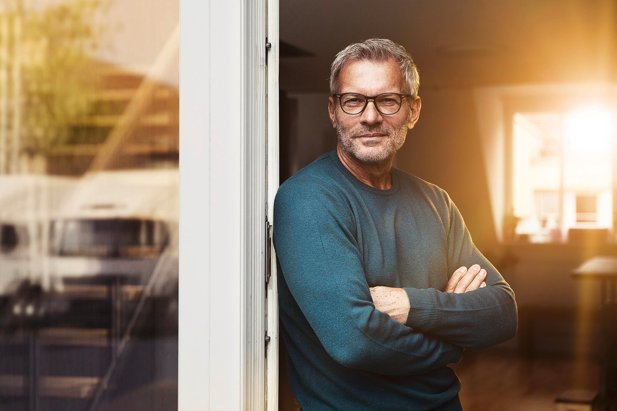 Fleet manager in his office A fleet manager wearing glases at the door of his office
