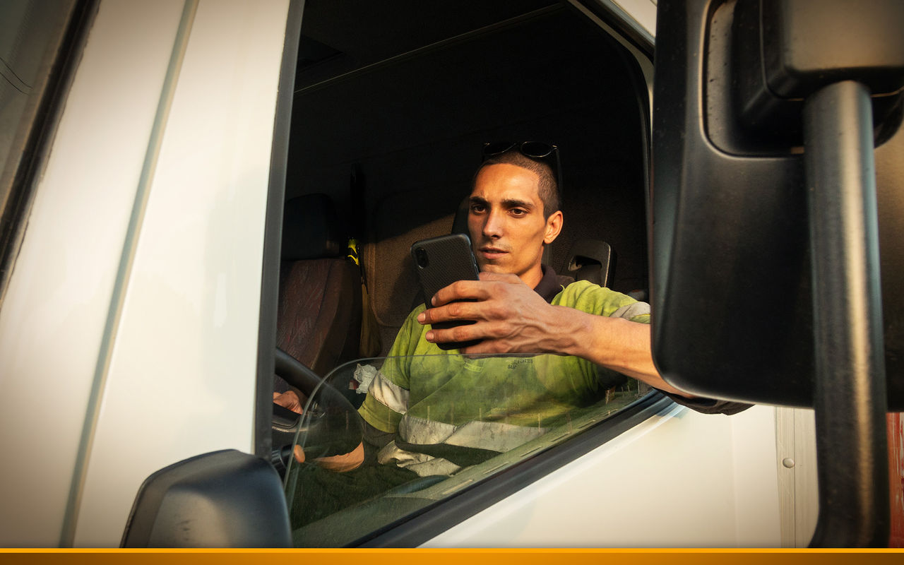 Trucker using his smartphone while driving