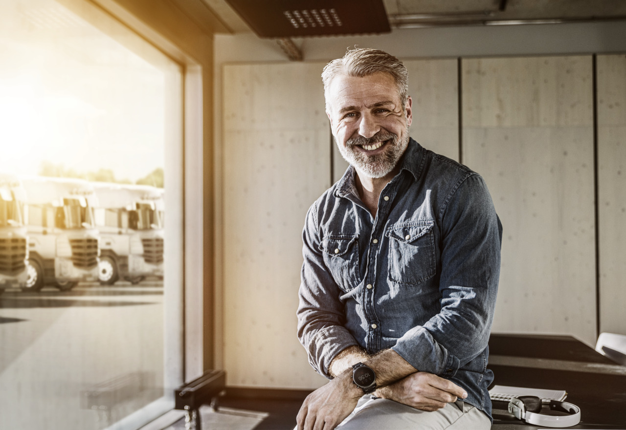 Portrait of smiling casual mature businessman in office