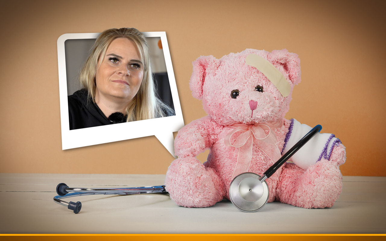 pink teddy bear with stethoscope on orange background