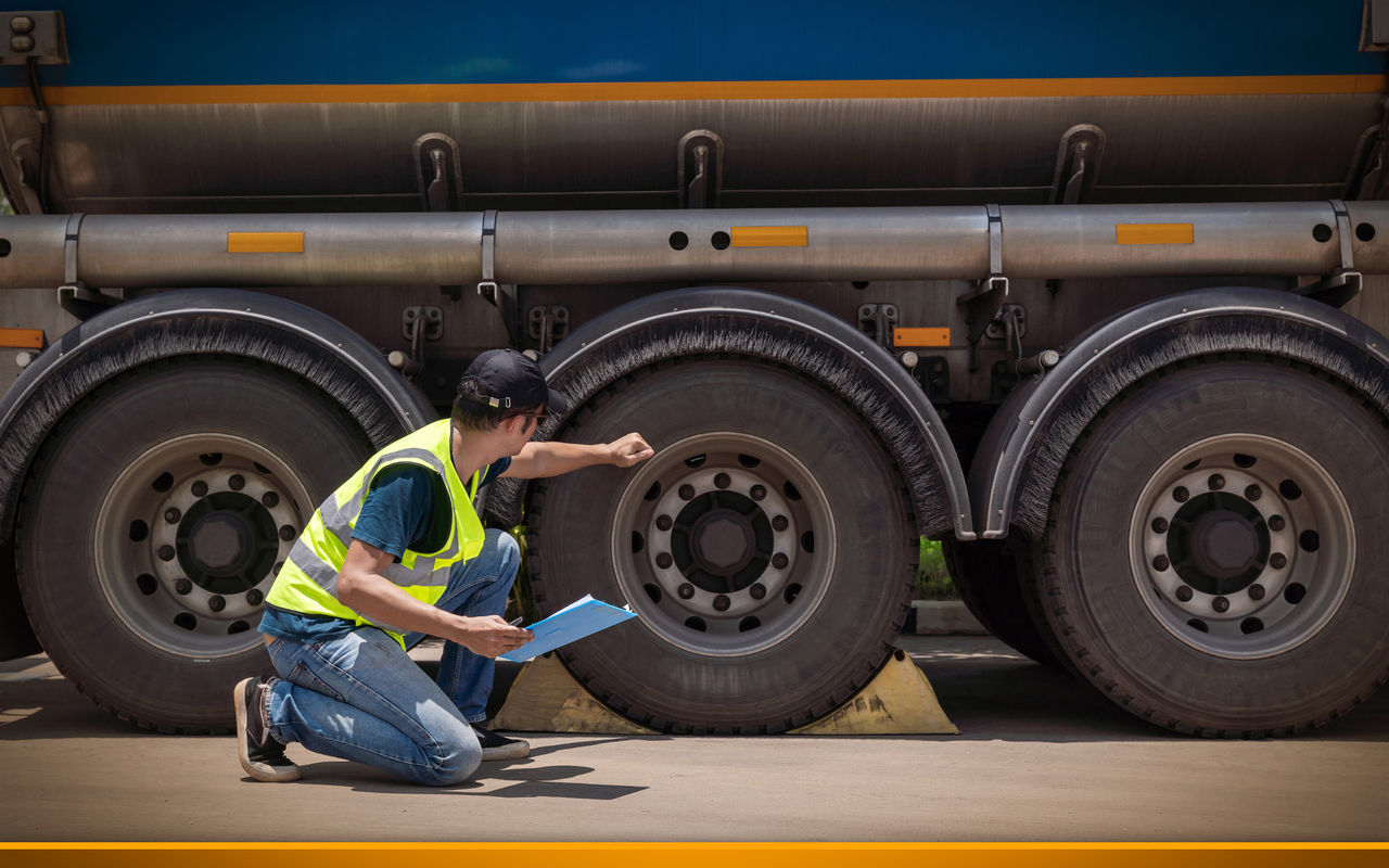 truck driver checking tires