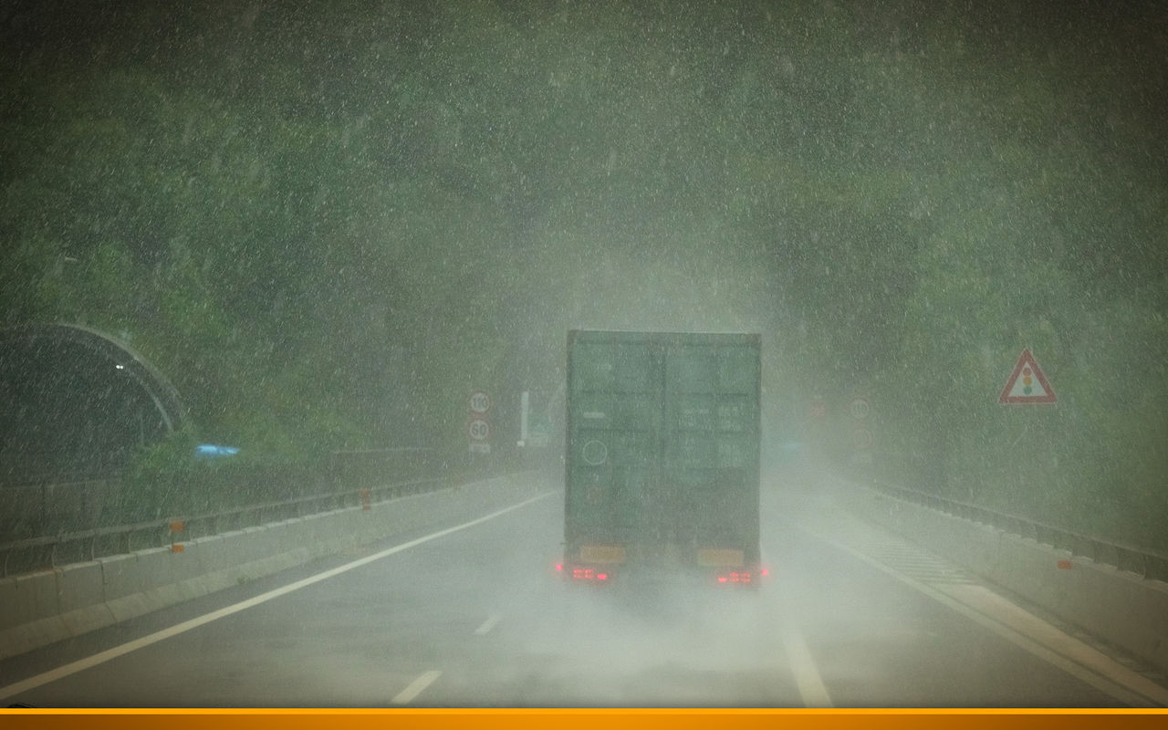 Truck on a highway during heavy rain