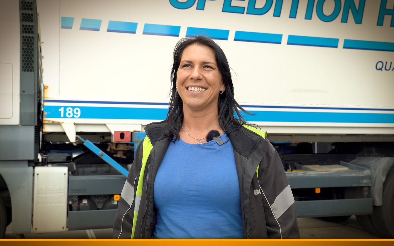 Truck driver in front of her truck